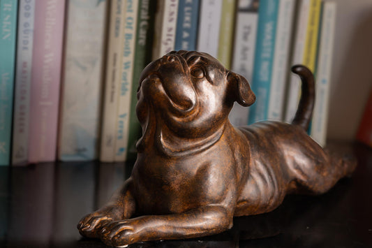 Close-up of pug figurine face and textured bronze finish